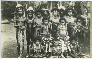 Item #14031 New Guinea men, women and children in ceremonial dress. Photographic postcard