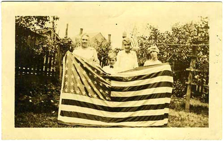 Item #20738 Family Holding Flag. Photograph.