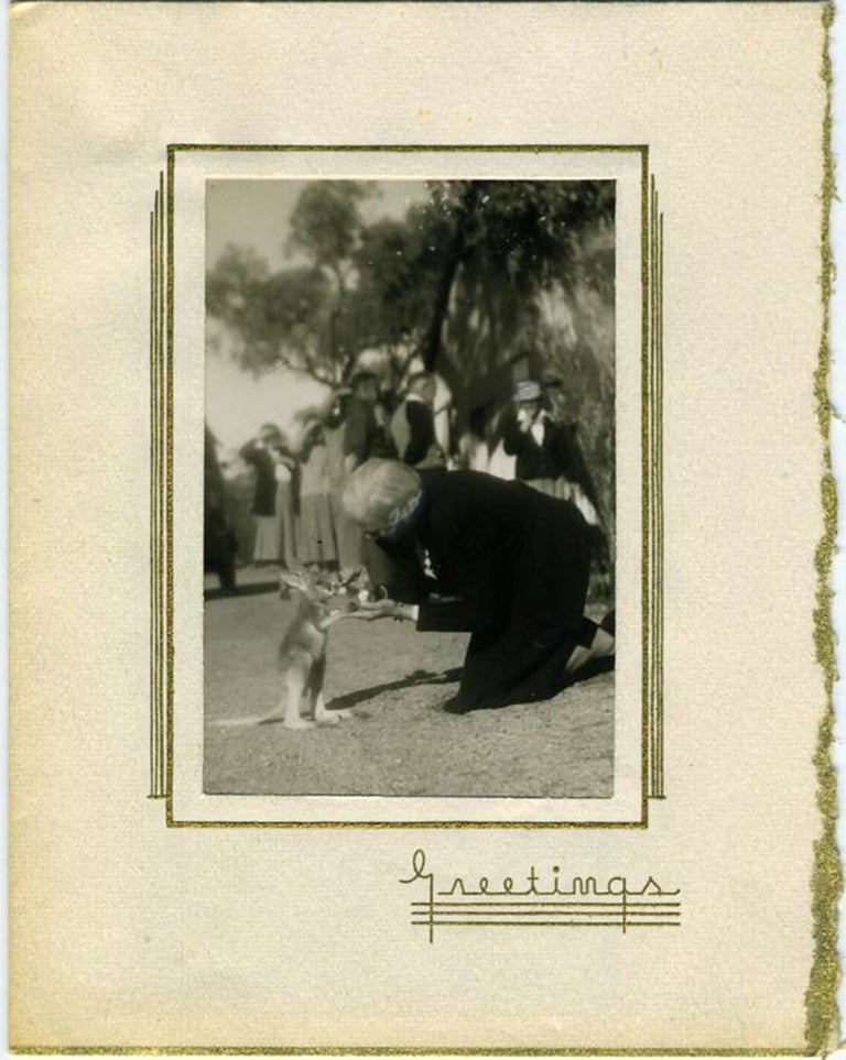 Item #21073 Real Photograph greeting card with image of woman feeding a "joey" Kangaroo.