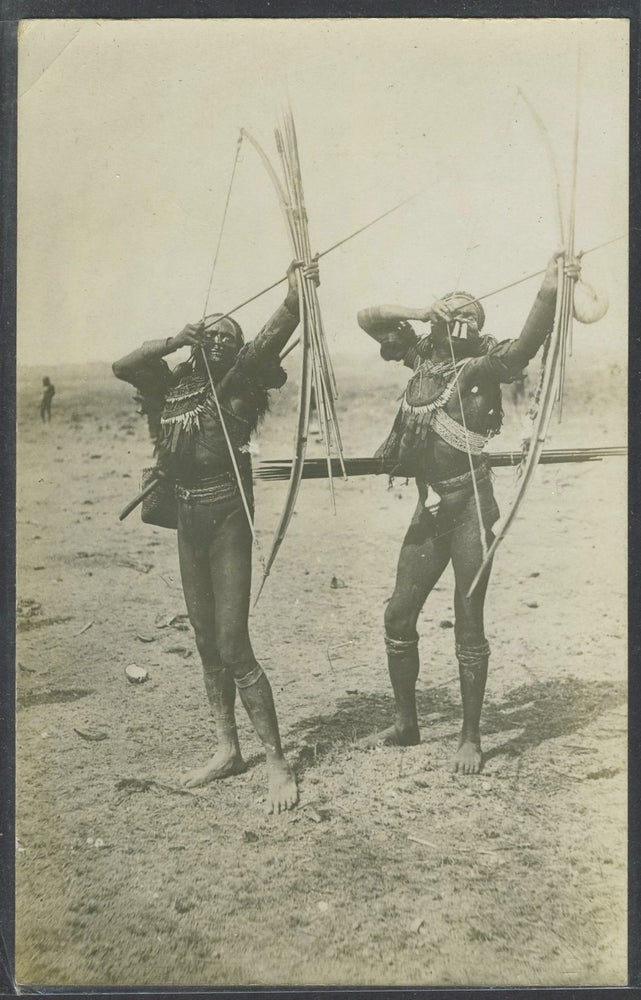 Item #23358 Real photo postcard of two Papua New Guinea tribesmen. New Guinea.